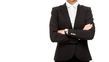 cropped shot of businesswoman in suit with crossed arms isolated on white