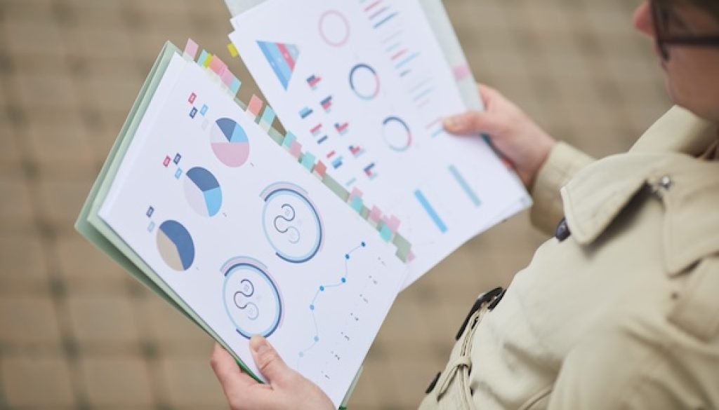 Unrecognizable Businessman Holding Charts Outdoors