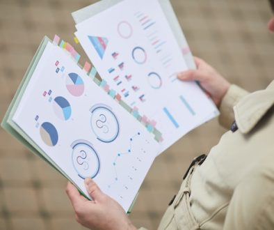 Unrecognizable Businessman Holding Charts Outdoors